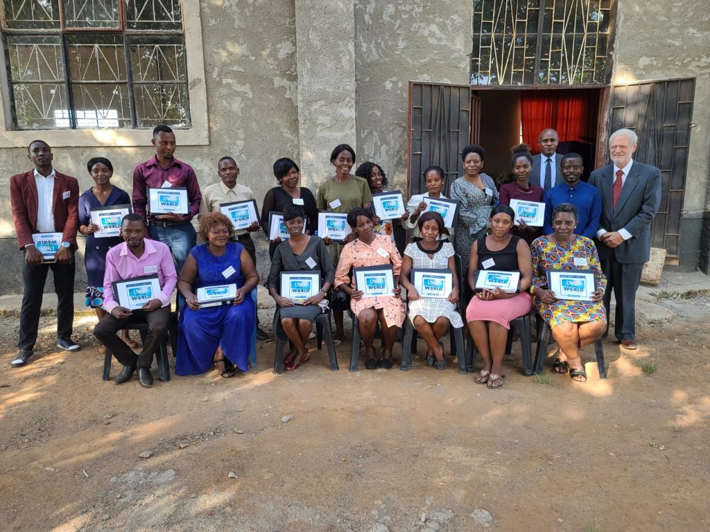 Zambian Primary School Teachers holding Light of the World Books